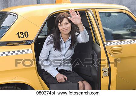 portrait of young businesswoman leaving yellow taxi View Large Photo Image Stock Image - portrait of young businesswoman leaving yellow taxi. Fotosearch