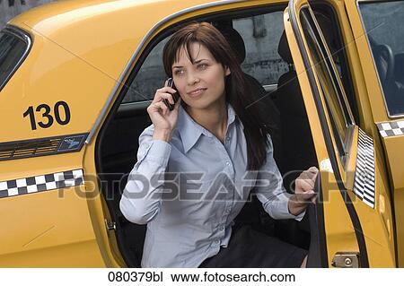 portrait of young businesswoman leaving yellow taxi talking on mobile phone View Large Photo Image Stock Image - portrait of young businesswoman leaving yellow taxi talking on mobile phone. Fotosearch