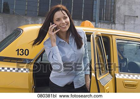 portrait of young businesswoman leaving yellow taxi talking on mobile phone View Large Photo Image Stock Image - portrait of young businesswoman leaving yellow taxi talking on mobile phone. Fotosearch