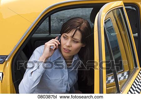 portrait of young businesswoman leaving yellow taxi talking on mobile phone View Large Photo Image Stock Image - portrait of young businesswoman leaving yellow taxi talking on mobile phone. Fotosearch