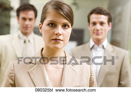 portrait of young businesswoman with two male colleagues in the background View Large Photo Image Stock Image - portrait of young businesswoman with two male colleagues in the background. Fotosearch