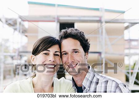 portrait of young couple in front of the construction site of their new home View Large Photo Image Stock Image - portrait of young couple in front of the construction site of their new home. Fotosearch