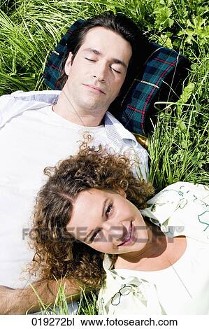 portrait of young couple relaxing in grass View Large Photo Image Stock Image - portrait of young couple relaxing in grass. Fotosearch