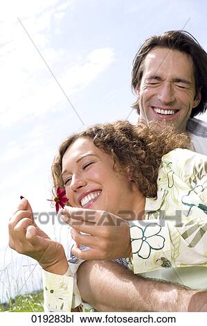 portrait of young couple woman picking flower View Large Photo Image Stock Image - portrait of young couple woman picking flower. Fotosearch