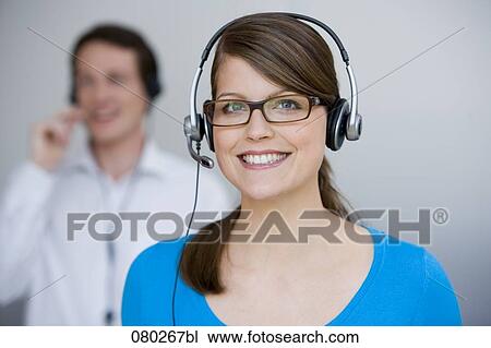 portrait of young female call center agent with male colleague in background View Large Photo Image Stock Image - portrait of young female call center agent with male colleague in background. Fotosearch