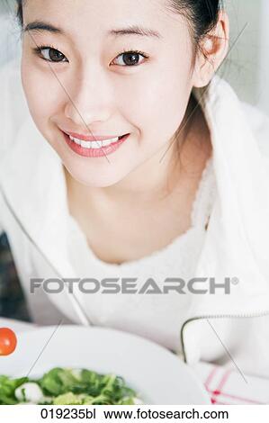 portrait of young japanese girl eating salad View Large Photo Image Stock Image - portrait of young japanese girl eating salad. Fotosearch