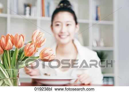 portrait of young japanese girl eating at table focus on tulips in vase View Large Photo Image Stock Image - portrait of young japanese girl eating at table focus on tulips in vase. Fotosearch