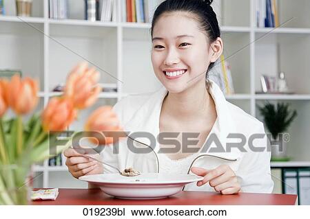 portrait of young japanese girl eating at table View Large Photo Image Stock Image - portrait of young japanese girl eating at table. Fotosearch