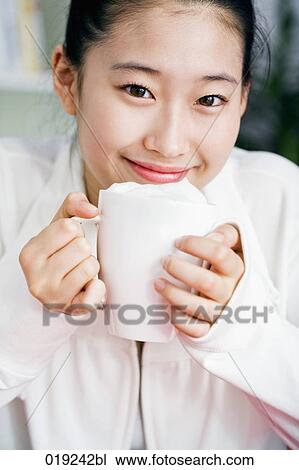 portrait of young japanese girl holding cup View Large Photo Image Stock Image - portrait of young japanese girl holding cup. Fotosearch