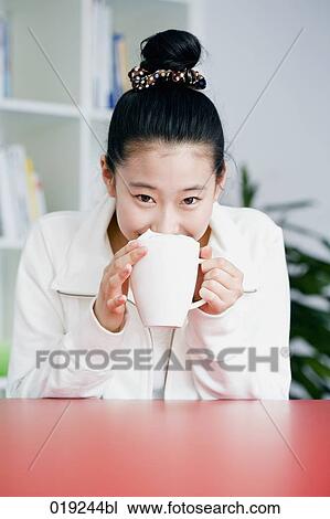 portrait of young japanese girl holding cup View Large Photo Image Stock Image - portrait of young japanese girl holding cup. Fotosearch