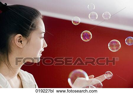 portrait of young japanese girl playing with soap bubbles View Large Photo Image Stock Image - portrait of young japanese girl playing with soap bubbles. Fotosearch