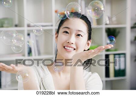 portrait of young japanese girl playing with soap bubbles View Large Photo Image Stock Image - portrait of young japanese girl playing with soap bubbles. Fotosearch
