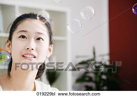portrait of young japanese girl playing with soap bubbles View Large Photo Image Stock Image - portrait of young japanese girl playing with soap bubbles. Fotosearch