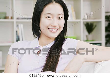 portrait of young japanese girl sitting on sofa View Large Photo Image Stock Image - portrait of young japanese girl sitting on sofa. Fotosearch