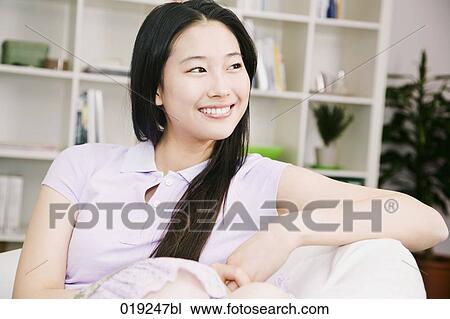 portrait of young japanese girl sitting on sofa View Large Photo Image Stock Image - portrait of young japanese girl sitting on sofa. Fotosearch