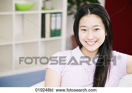portrait of young japanese girl sitting on sofa View Large Photo Image Stock Image - portrait of young japanese girl sitting on sofa. Fotosearch