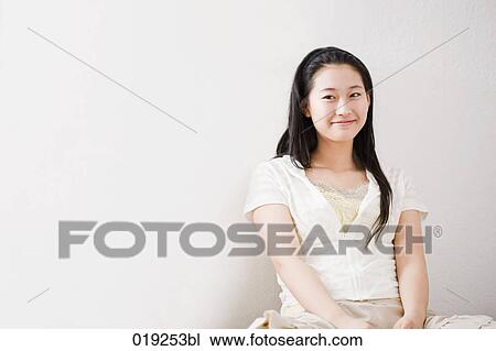 portrait of young japanese girl sitting against wall View Large Photo Image Stock Image - portrait of young japanese girl sitting against wall. Fotosearch