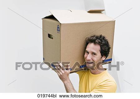 portrait of young man carrying moving box View Large Photo Image Stock Image - portrait of young man carrying moving box. Fotosearch