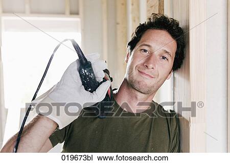 portrait of young man standing in door of house under construction View Large Photo Image Stock Image - portrait of young man standing in door of house under construction. Fotosearch