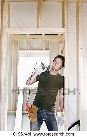 portrait of young man standing in door of house under construction View Large Photo Image Stock Image - portrait of young man standing in door of house under construction. Fotosearch