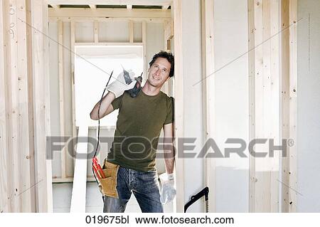 portrait of young man standing in door of house under construction View Large Photo Image Stock Image - portrait of young man standing in door of house under construction. Fotosearch