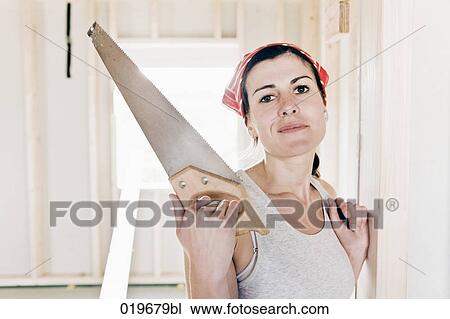 portrait of young woman on construction site holding saw View Large Photo Image Stock Image - portrait of young woman on construction site holding saw. Fotosearch