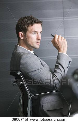 profile of businessman sitting in office chair View Large Photo Image Stock Image - profile of businessman sitting in office chair. Fotosearch