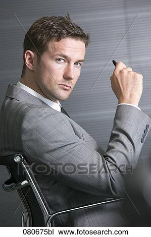 profile of businessman sitting in office chair View Large Photo Image Stock Image - profile of businessman sitting in office chair. Fotosearch
