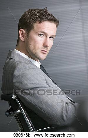 profile of businessman sitting in office chair View Large Photo Image Stock Image - profile of businessman sitting in office chair. Fotosearch