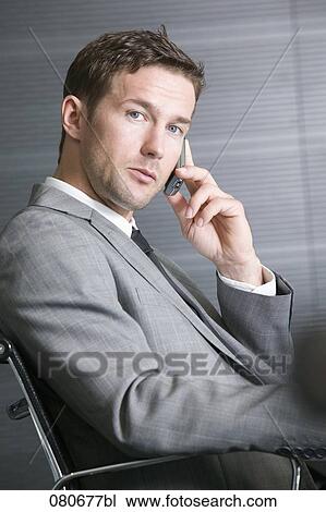profile of businessman sitting in office chair talking on mobile phone View Large Photo Image Stock Image - profile of businessman sitting in office chair talking on mobile phone. Fotosearch