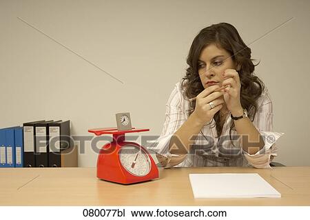 secretary looking at watch standing on red scales View Large Photo Image Stock Image - secretary looking at watch standing on red scales. Fotosearch