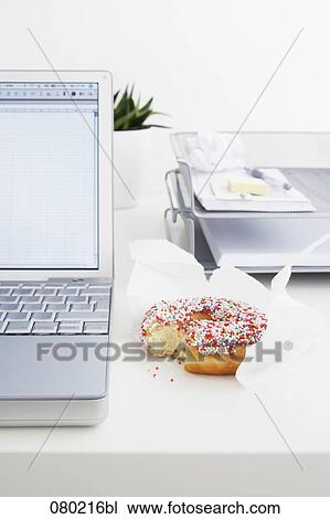 still life of colourful donut on office desk View Large Photo Image Stock Image - still life of colourful donut on office desk. Fotosearch