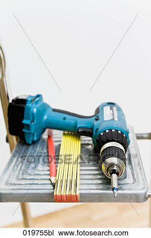 still life of cordless screwdriver folding rule and pencil on ladder View Large Photo Image Stock Image - still life of cordless screwdriver folding rule and pencil on ladder. Fotosearch