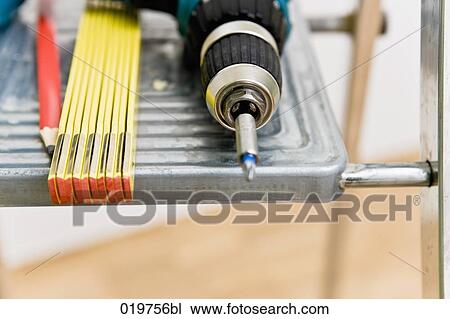 still life of cordless screwdriver folding rule and pencil on ladder View Large Photo Image Stock Image - still life of cordless screwdriver folding rule and pencil on ladder. Fotosearch