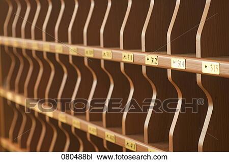Stock Image - still life of empty pigeon holes at hotel reception. Fotosearch