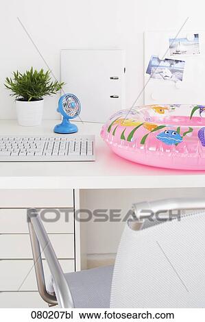 still life of fan and floating tyre on empty office desk View Large Photo Image Stock Image - still life of fan and floating tyre on empty office desk. Fotosearch