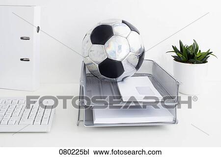 still life of football in tray on office desk View Large Photo Image Stock Image - still life of football in tray on office desk. Fotosearch