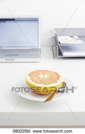 still life of grapefruit on plate on office desk View Large Photo Image Stock Image - still life of grapefruit on plate on office desk. Fotosearch