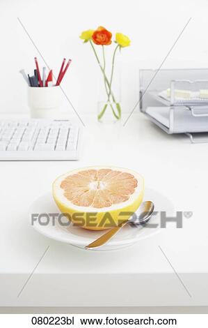 still life of grapefruit on plate on office desk View Large Photo Image Stock Image - still life of grapefruit on plate on office desk. Fotosearch