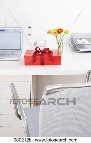 Stock Image - still life of present on office desk. Fotosearch