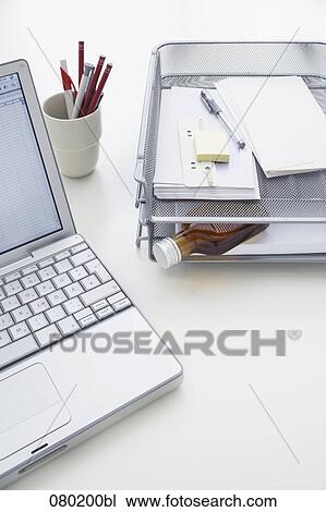 still life of small alcohol bottle in tray on office desk View Large Photo Image Stock Image - still life of small alcohol bottle in tray on office desk. Fotosearch