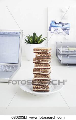 still life of sweets piled on office desk View Large Photo Image Stock Image - still life of sweets piled on office desk. Fotosearch