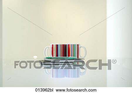 still life of two colourful mugs on two black books on a glass table View Large Photo Image Stock Image - still life of two colourful mugs on two black books on a glass table. Fotosearch