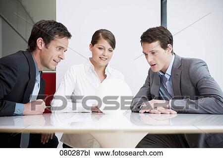 three business people sitting around table looking at crystal ball View Large Photo Image Stock Image - three business people sitting around table looking at crystal ball. Fotosearch