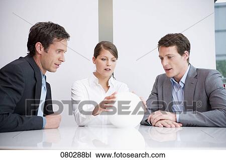 three business people sitting around table looking at crystal ball View Large Photo Image Stock Image - three business people sitting around table looking at crystal ball. Fotosearch