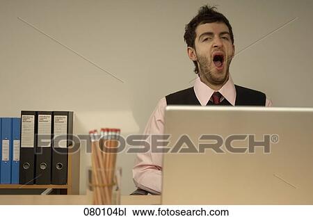 tired businessman yawning View Large Photo Image Stock Image - tired businessman yawning. Fotosearch
