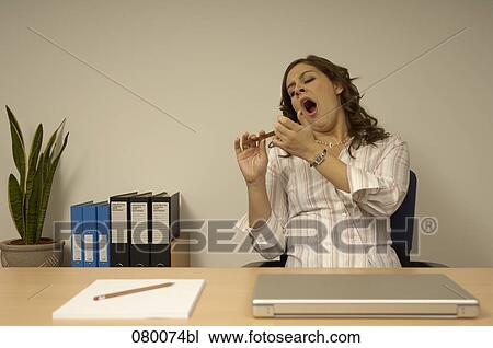 tired secretary filing her fingernails View Large Photo Image Stock Image - tired secretary filing her fingernails. Fotosearch