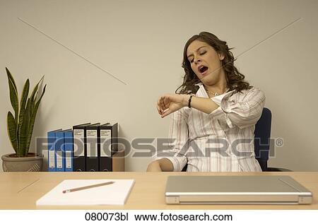tired secretary looking at her watch View Large Photo Image Stock Image - tired secretary looking at her watch. Fotosearch