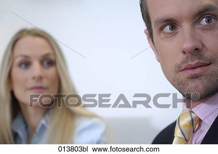 Stock Image - two business people during conference. Fotosearch