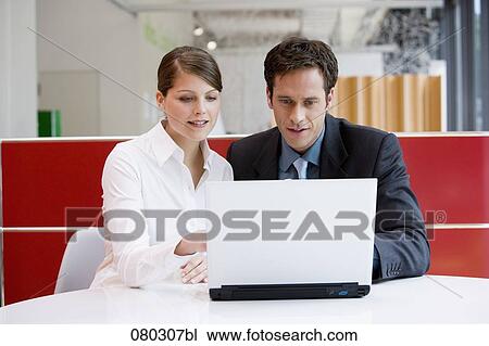 two business people working at laptop together View Large Photo Image Stock Image - two business people working at laptop together. Fotosearch